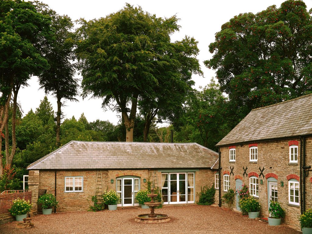 Image may contain Architecture Building Cottage House Housing Plant Tree Door Grass Vegetation and Outdoors