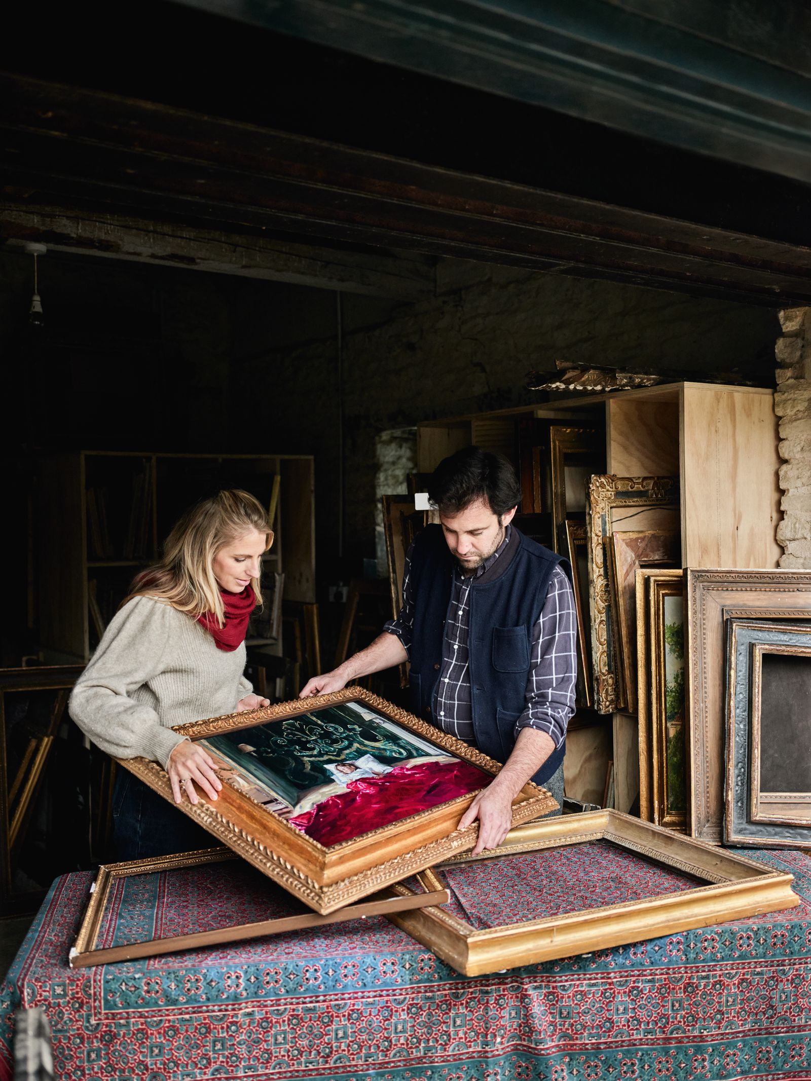 Artist Phoebe Dickinson and her husband Luke Rodgers discuss the framing of one of her works.